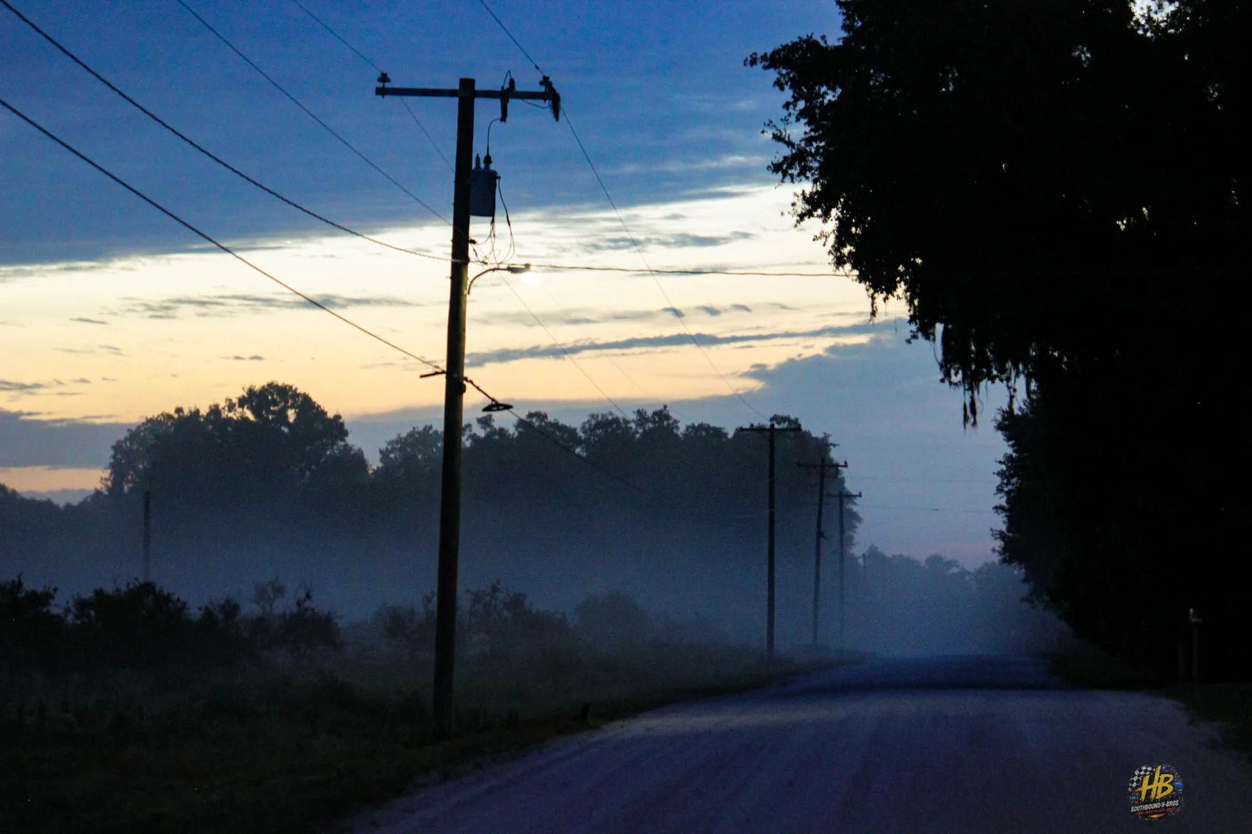 Misty rural road at dawn