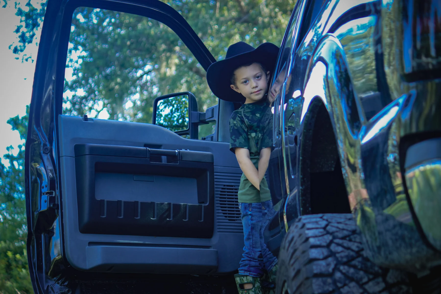 Child portrait beside truck
