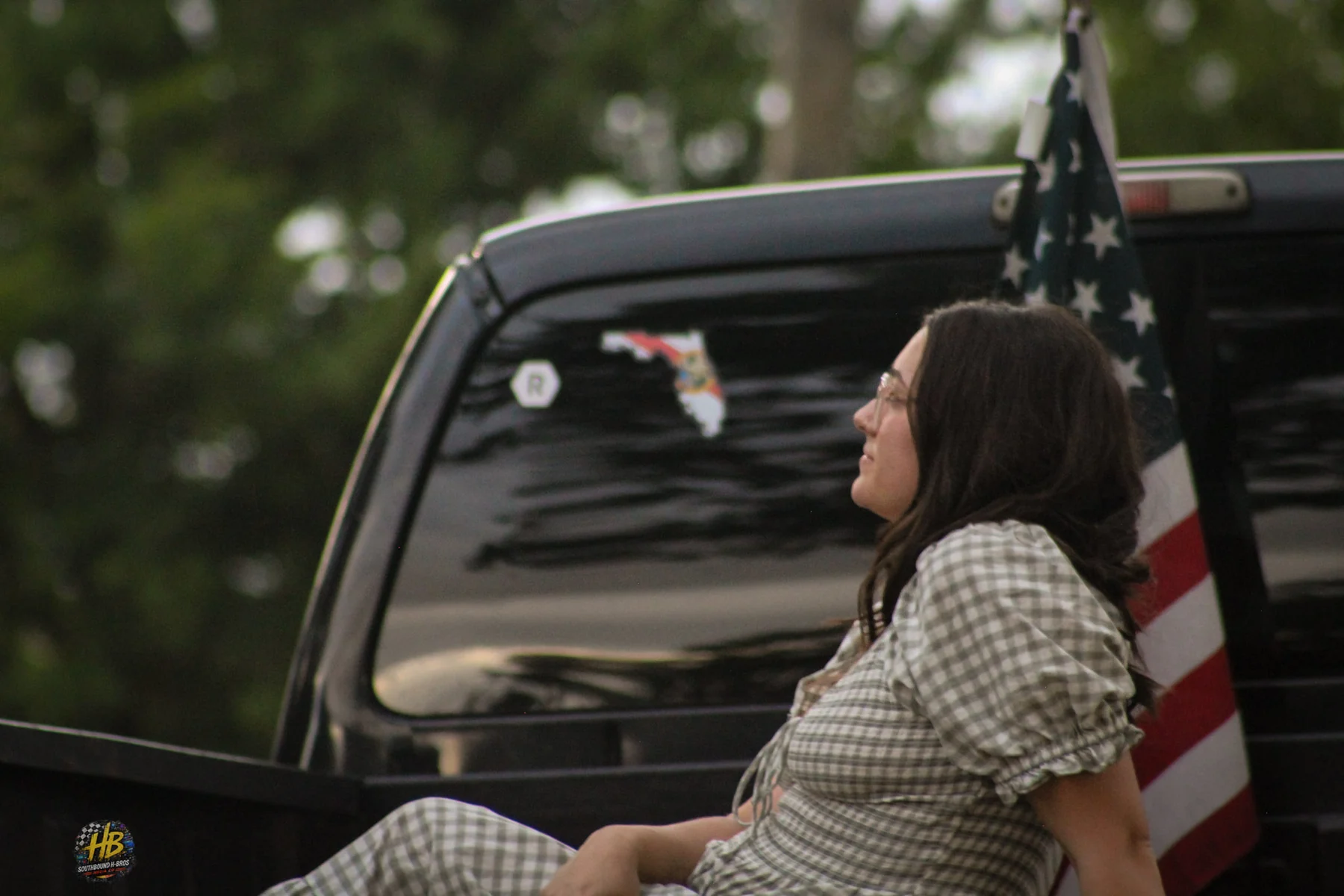 Lifestyle portrait beside truck and American flag